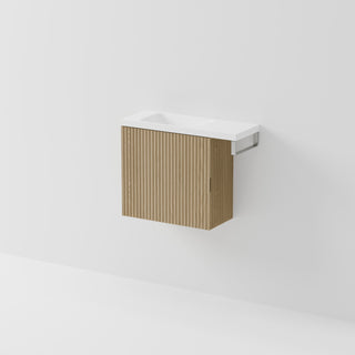 Aria 550 wall-hung WC vanity in Light Ash timber with an offset basin and integrated Brushed Nickel hand towel rail, shown against a white background.