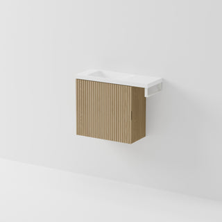 Aria 550 wall-hung WC vanity in Light Ash timber with an offset basin and integrated Matte White hand towel rail, shown against a white background.