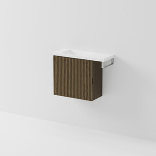 Aria 550 wall-hung WC vanity in Smoked Ash timber with an offset basin and integrated Brushed Nickel hand towel rail, shown against a white background.