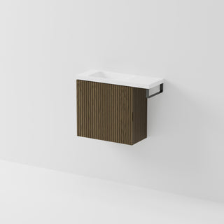Aria 550 wall-hung WC vanity in Smoked Ash timber with an offset basin and integrated Gunmetal hand towel rail, shown against a white background.