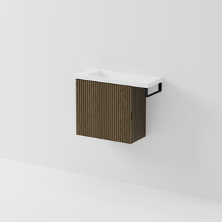 Aria 550 wall-hung WC vanity in Smoked Ash timber with an offset basin and integrated Matte Black hand towel rail, shown against a white background.