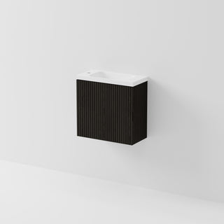 A modern wall-mounted bathroom vanity with a black ribbed cabinet and a white integrated sink basin, shown against a clean white wall.