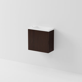 A modern wall-mounted bathroom vanity with a dark brown vertically slatted cabinet and a white ceramic basin, shown against a clean white wall.