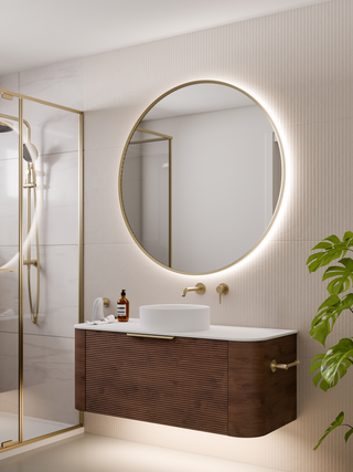 code-interiors-brushed-brass-aura-round-led-mirror-in-bathroom-setting